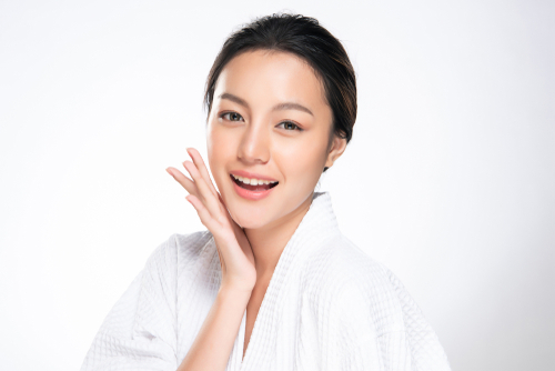 woman touching soft cheek and smile with clean and fresh skin