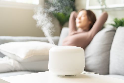 happy blurred asian young woman, girl enjoying aromatherapy steam scent