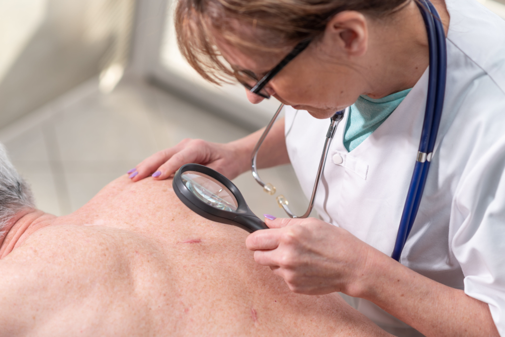 A Mohs surgeon examining a patient’s skin before Mohs surgery Fellowship-Trained Mohs Surgeon Sarasota FL