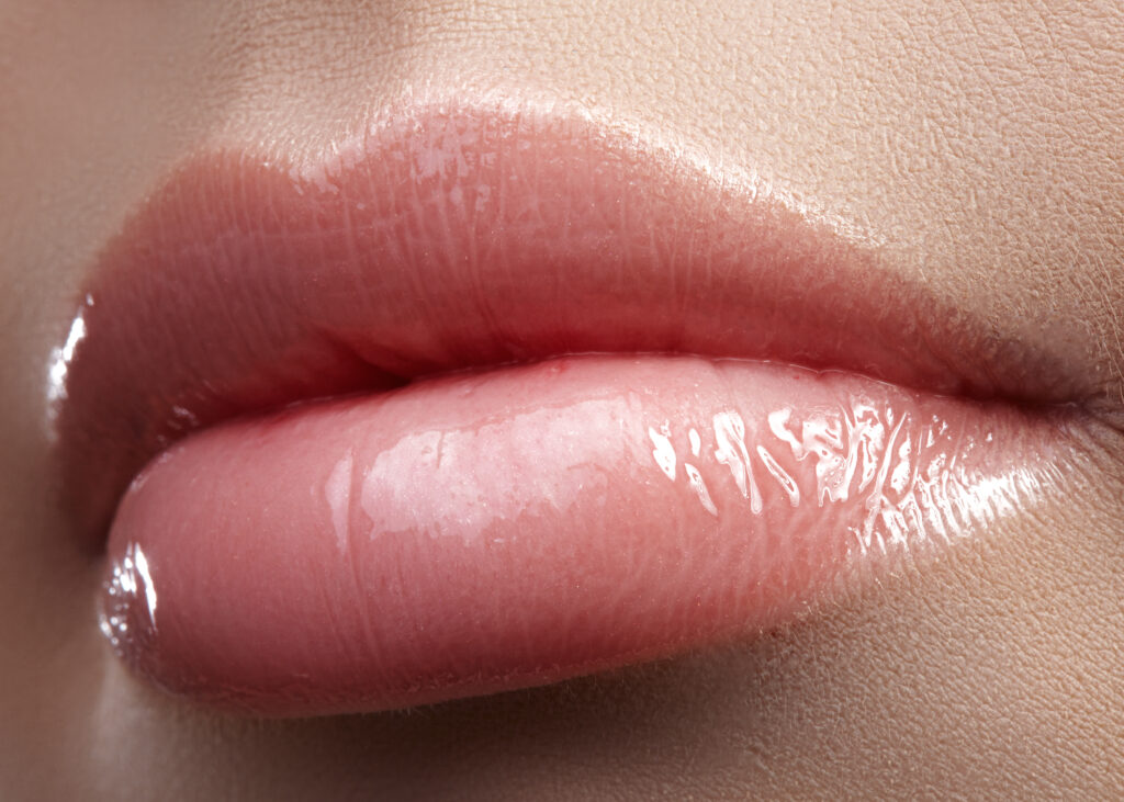 Close up of woman’s pink, full lips from BOTOX lip flip in Sarasota, FL.