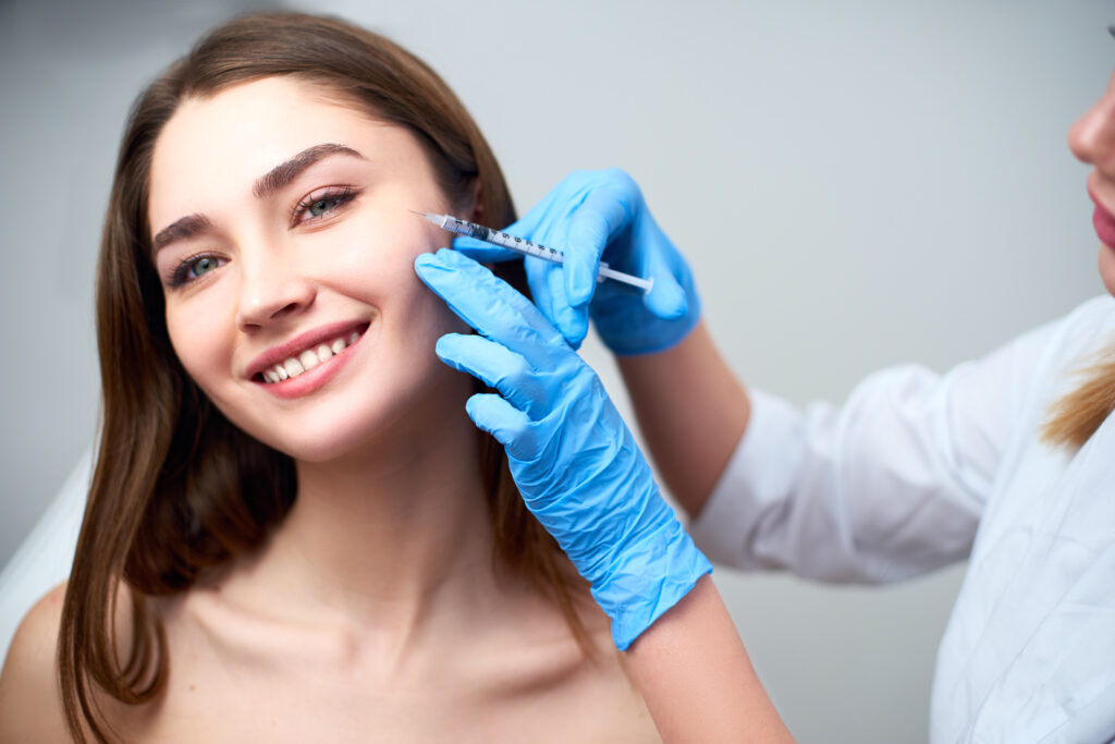 A woman getting a dermal filler injection in her cheek