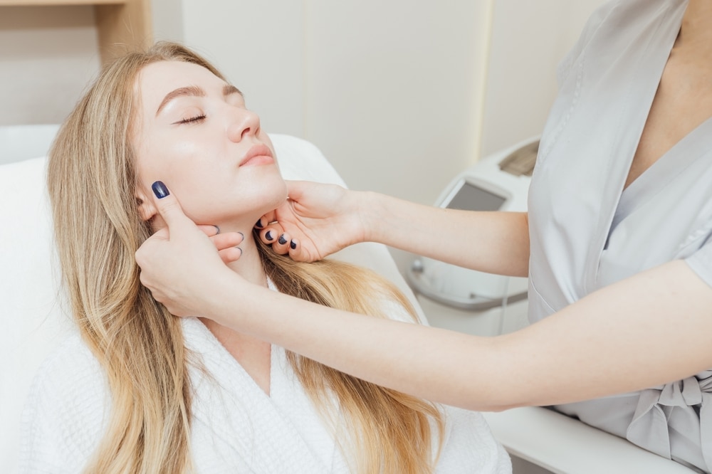 Expert cosmetologist analyzing a patient’s facial skin before performing SmartXide DOT laser resurfacing, a precision treatment for skin rejuvenation, texture improvement, and anti-aging care. Expert cosmetologist analyzing a patient’s facial skin before performing SmartXide DOT laser resurfacing, a precision treatment for skin rejuvenation, texture improvement, and anti-aging care.