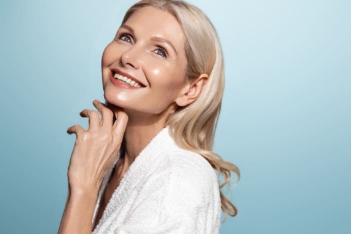 Menopausal woman manages to maintain glowing skin with deliberate skincare.
